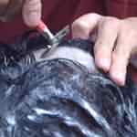Close-up on the blade shaving his skull