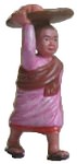 Plastic nun, carrying a platter on the head